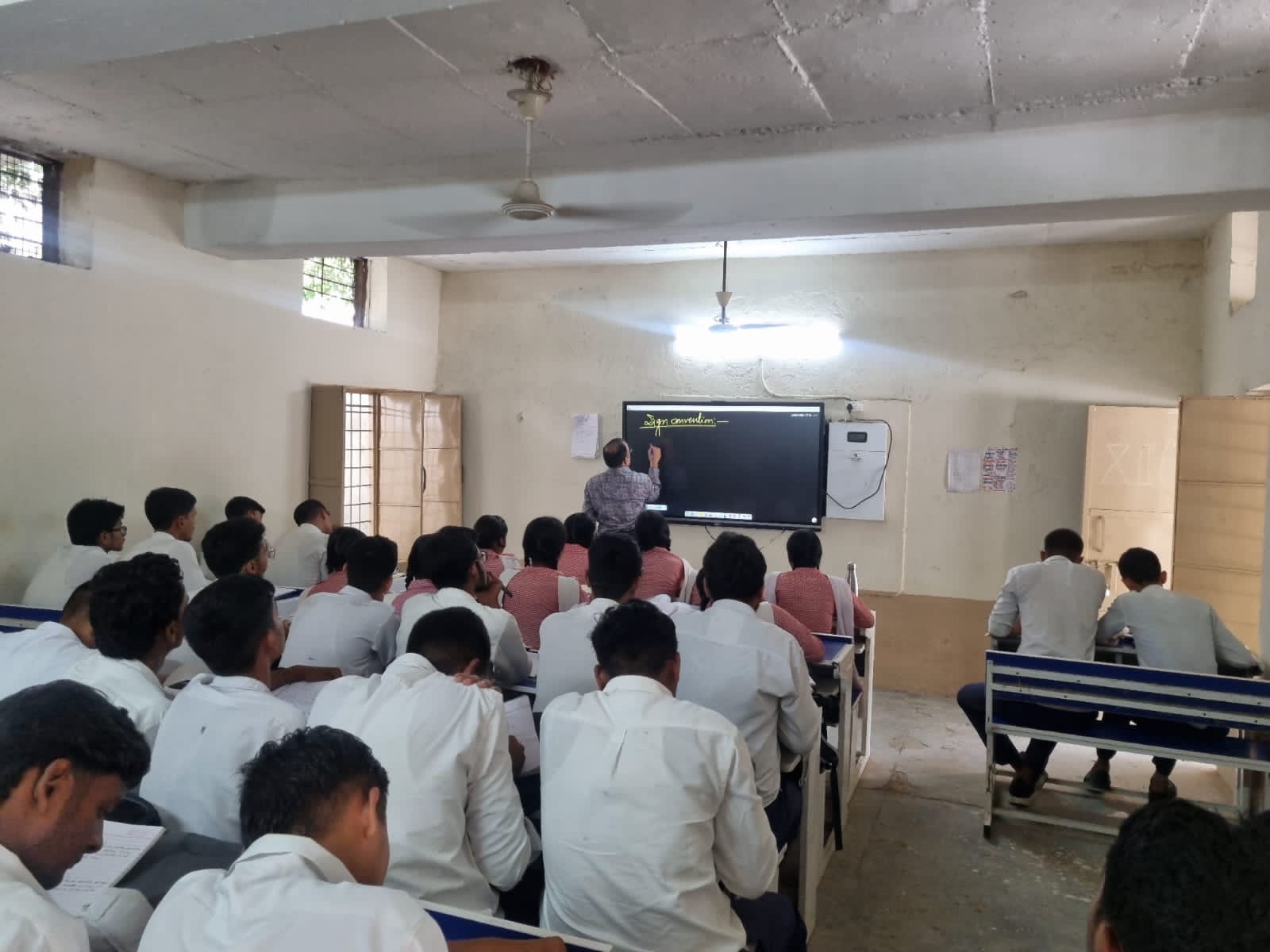 Students and teacher engaged in classroom learning